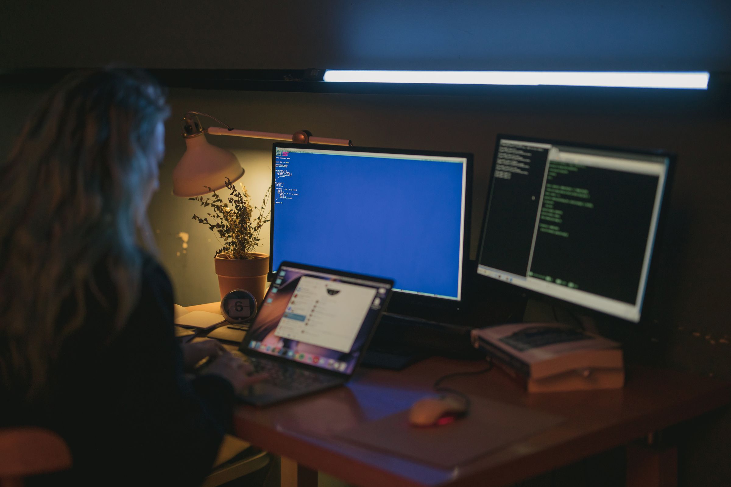 Engineer working across several monitors